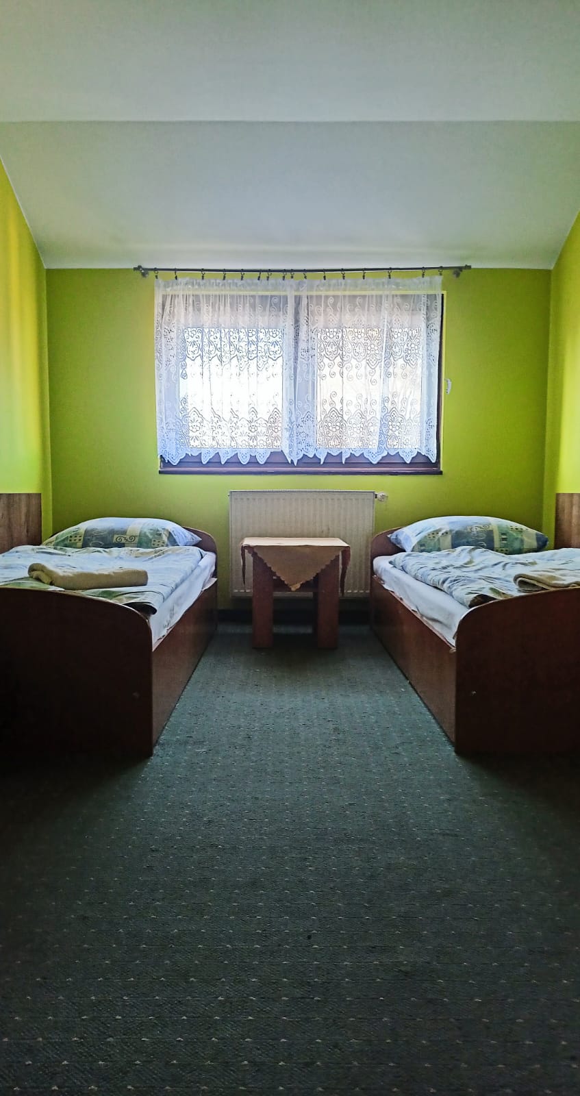 2 single beds on each side of central window